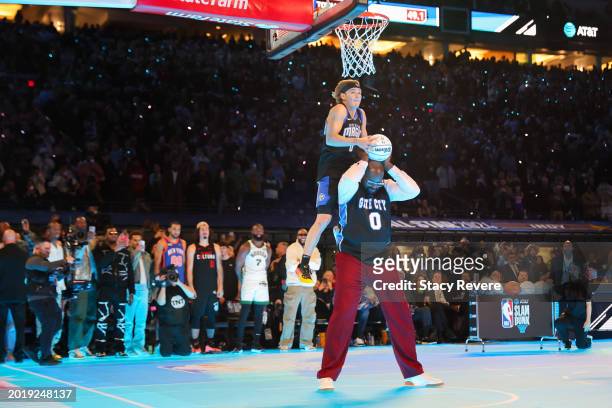 Mac McClung of the Osceola Magic dunks the ball over Shaquille O'Neal in the 2024 AT&T Slam Dunk contest during the State Farm All-Star Saturday...