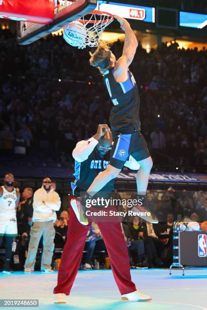 Mac McClung of the Osceola Magic dunks the ball over Shaquille O'Neal in the 2024 AT&T Slam Dunk contest during the State Farm All-Star Saturday...