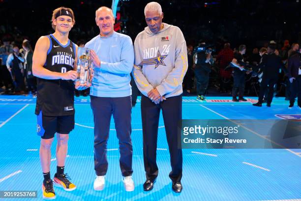Mac McClung of the Osceola Magic poses for a photo with AT&T CEO John Stankey and Julius Erving after winning the 2024 AT&T Slam Dunk contest during...