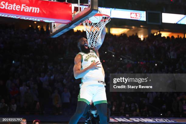 Jaylen Brown of the Boston Celtics dunks the ball over Donovan Mitchell of the Cleveland Cavaliers in the 2024 AT&T Slam Dunk contest during the...