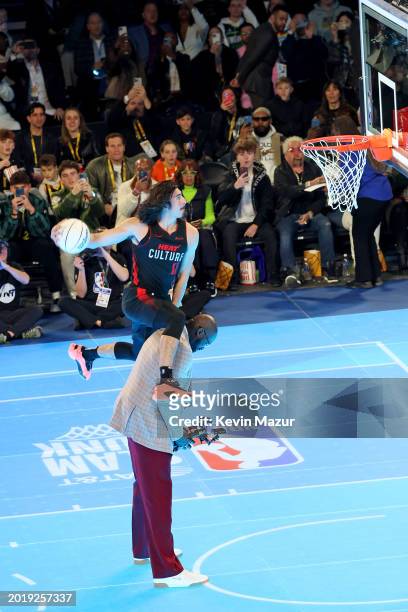 Jaime Jaquez Jr. Jumps over Shaquille O'Neal during the AT&T Slam Dunk Contest as part of 2024 State Farm All-Star Saturday Night at Lucas Oil...