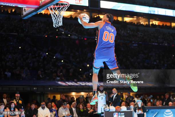 Jacob Toppin of the New York Knicks participates in the 2024 AT&T Slam Dunk contest during the State Farm All-Star Saturday Night at Lucas Oil...
