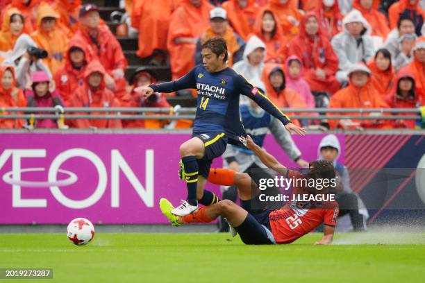 Junya Ito of Kashiwa Reysol is tackled by Kazuma Takayama of Omiya Ardija during the J.League J1 match between Omiya Ardija and Kashiwa Reysol at...