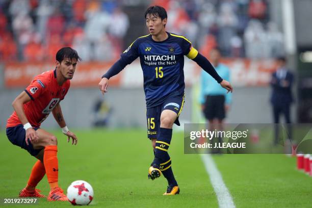 Kim Bo-kyung of Kashiwa Reysol controls the ball against Aria Jasuru Hasegawa of Omiya Ardija during the J.League J1 match between Omiya Ardija and...