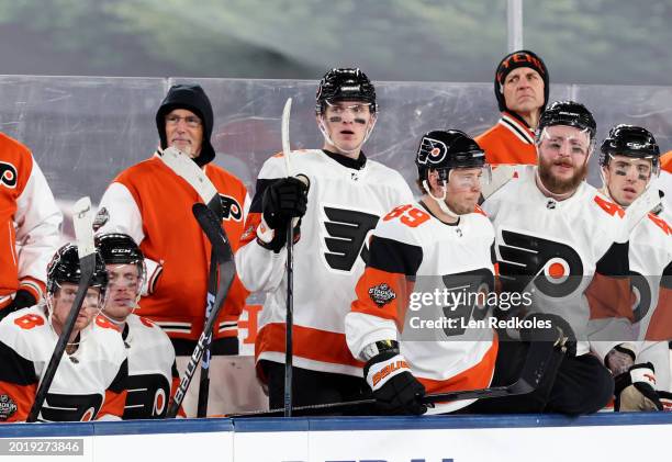 Head coach John Tortorella of the Philadelphia Flyers looks on with his coaching staff from behind the bench during the second period of the 2024...