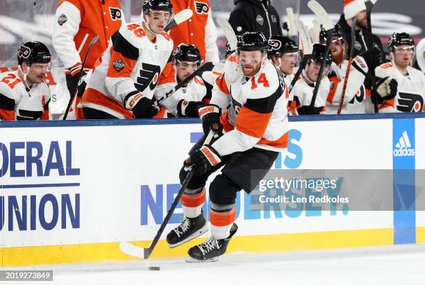 Sean Couturier of the Philadelphia Flyers skates with the puck during the third period of the 2024 Navy Federal Credit Union Stadium Series game...