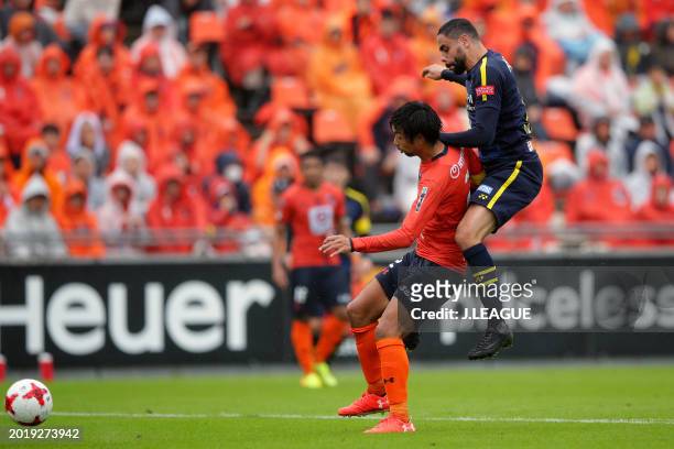 Kosuke Kikuchi of Omiya Ardija controls the ball against Diego Oliveira of Kashiwa Reysol during the J.League J1 match between Omiya Ardija and...
