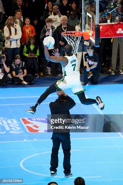 Jaylen Brown jumps over Donovan Mitchell during the AT&T Slam Dunk Contest as part of 2024 State Farm All-Star Saturday Night at Lucas Oil Stadium on...