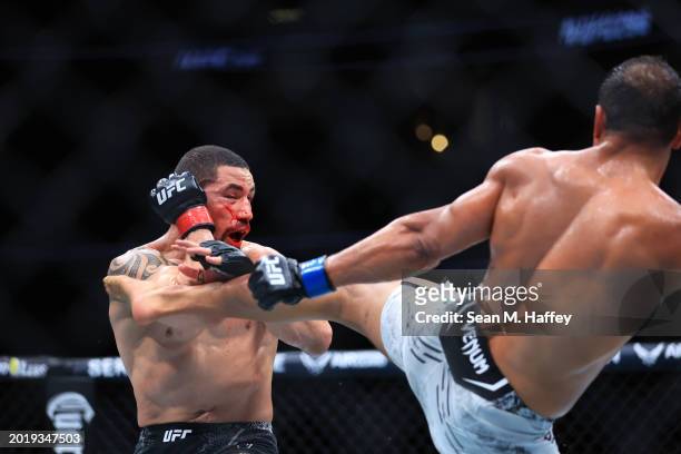 Robert Whittaker of New Zealand exchanges strikes with Paulo Costa of Brazil in their middleweight fight during UFC 298 at Honda Center on February...