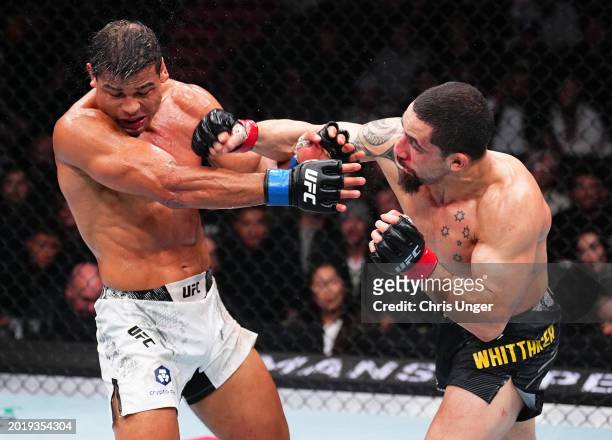 Robert Whittaker of New Zealand punches Paulo Costa of Brazil in a middleweight fight during the UFC 298 event at Honda Center on February 17, 2024...