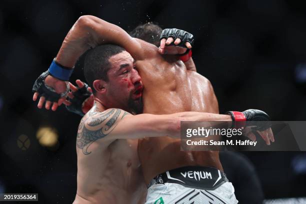 Robert Whittaker of New Zealand exchanges strikes with Paulo Costa of Brazil in their middleweight fight during UFC 298 at Honda Center on February...