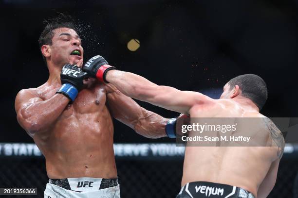 Robert Whittaker of New Zealand punches Paulo Costa of Brazil in their middleweight fight during UFC 298 at Honda Center on February 17, 2024 in...