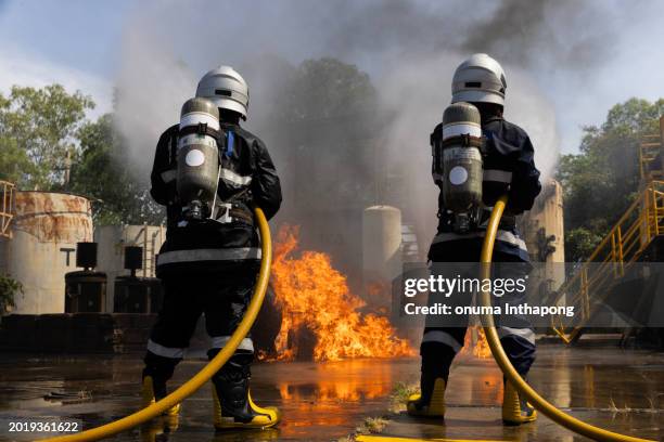 advanced fire fighter practice or training, firefighter battling flame - fire explosion stock pictures, royalty-free photos & images
