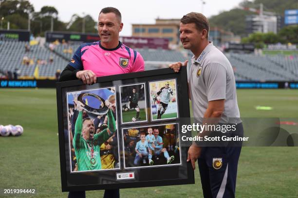 Danny Vukovic of the Mariners celebrates his 150th game reciving a photo from Mriners coach Mark Jackson during the A-League Men round 17 match...