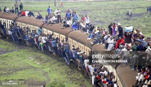 Kenyan passengers hang onto an overloaded train on January 5, 2010 in Nairobi after public transport was paralyzed in the main Kenyan cities as...