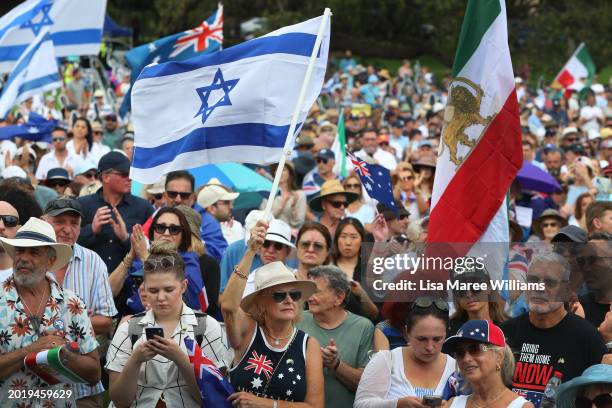 Protestors hold placards and flags during a rally against anti-semitism at The Domain on February 18, 2024 in Sydney, Australia. In response to a...