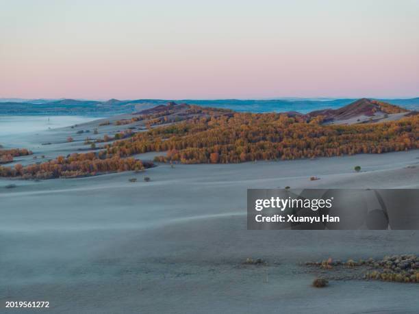 autumn grasslands covered in fog at sunrise - chifeng stock pictures, royalty-free photos & images