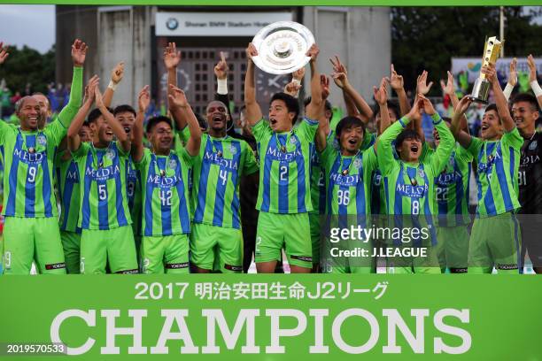 Captain Shunsuke Kikuchi of Shonan Bellmare lifts the J2 Champions plaque at the award ceremony following the J.League J2 match between Shonan...