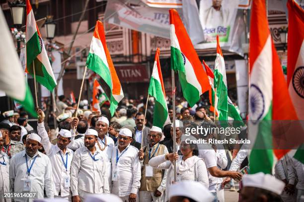 India's Congress Party workers watch as leader Rahul Gandhi takes part in a roadshow as part of his 'Bharat Jodo Nyay Yatra' on February 17, 2024 in...