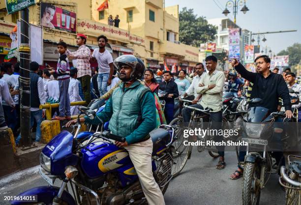 Bystanders watch as India's Congress Party leader Rahul Gandhi takes part in a roadshow as part of his 'Bharat Jodo Nyay Yatra' on February 17, 2024...