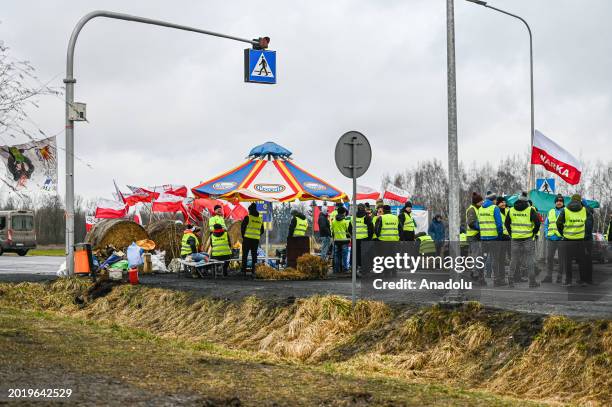 Polish farmers stand on the middle of the road during the ongoing blockade by Polish farmers at the Polish-Ukrainian border in Dorohusk, Poland on...