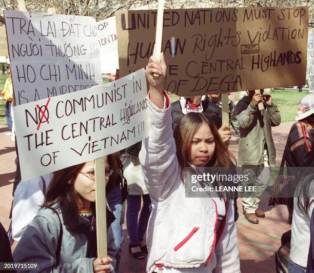 Montagnard protesters carrying the US and South Vietnamese flags demonstrate against human rights violations by the Vietnamese 12 March 2001 in...