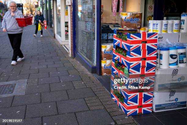 British produce for sale, in this Union flag boxes of flowering plants, outside a bargain shop on Kings Heath High Street on 22nd January 2024 in...