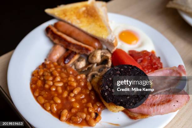 Full English breakfast on a plate in a 'greasy spoon' cafe on 3rd February 2024 in Birmingham, United Kingdom. Also known as a caf, these places...