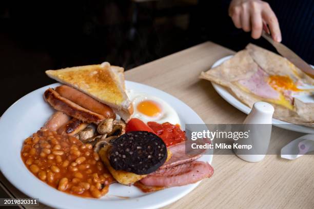 Full English breakfast on a plate in a 'greasy spoon' cafe on 3rd February 2024 in Birmingham, United Kingdom. Also known as a caf, these places...