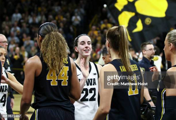 Guard Caitlin Clark of the Iowa Hawkeyes interacts with the opposing players after breaking the NCAA womens all-time scoring record during the...