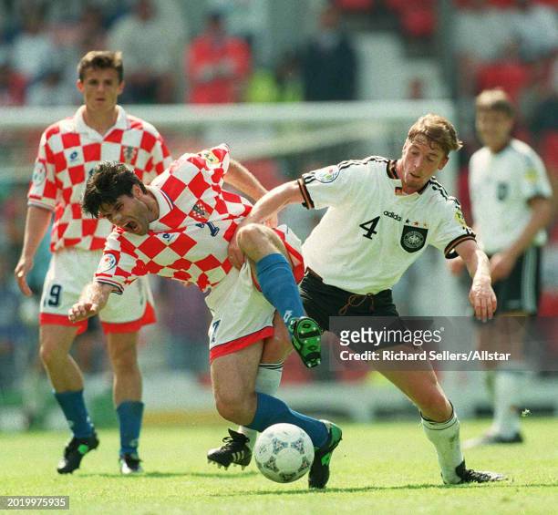 June 23: Steffen Freund of Germany and Aljosa Asanovic of Croatia challenge during the UEFA Euro 1996 Quarter Final match between Germany and Croatia...
