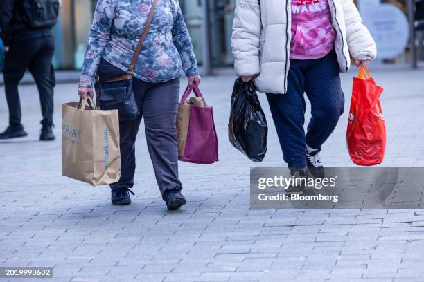 Shoppers with carrier bags in a shopping precinct in central Birmingham, UK, on Tuesday, Feb. 20, 2024. UK retail sales posted the biggest monthly...