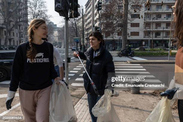 Volunteer use grabber tools to pick up trash while taking part in a cleanup event organized by Plastic Free on February 18, 2024 in Corso Sempione,...