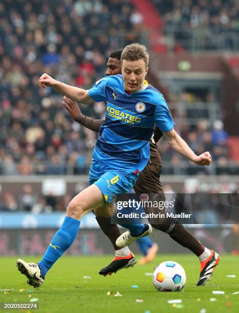 Robert Ivanov of Eintracht Braunschweig is challenged by Oladapo Afolayan of FC St. Pauli during the Second Bundesliga match between FC St. Pauli and...