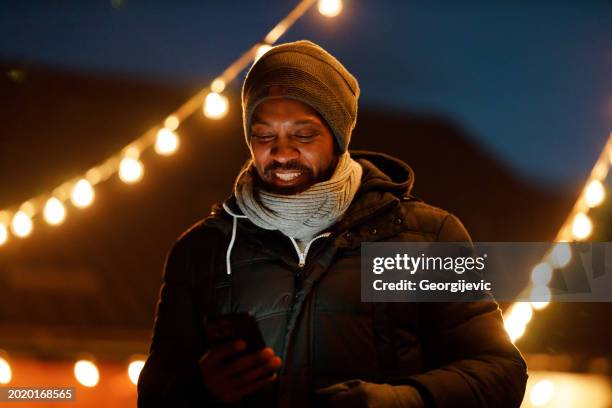 a man is using smartphone - hot latin nights stock pictures, royalty-free photos & images