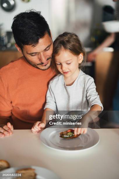 from above photo of a smiling dad having a breakfast with his little girl at home - girl making sandwich stock pictures, royalty-free photos & images