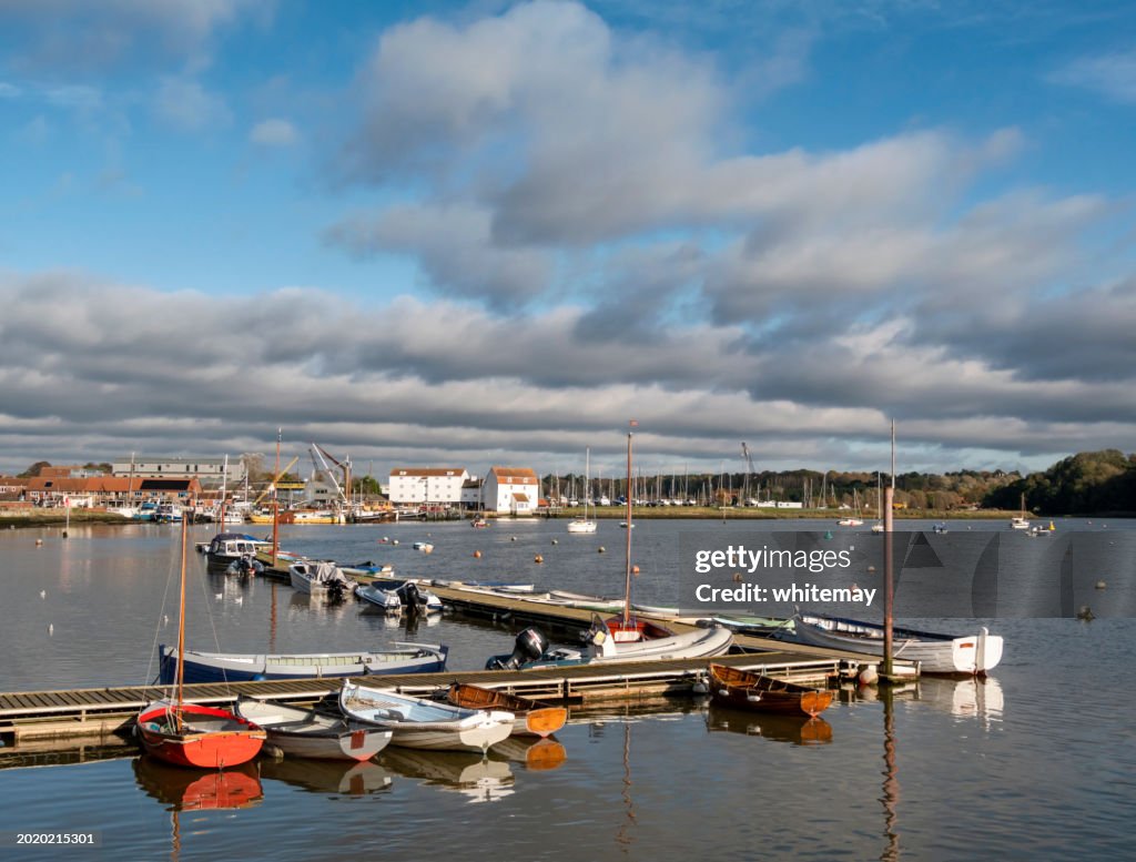 Small boats moored at a jetty in Woodbridge, Suffolk