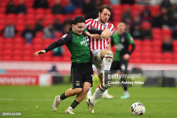 Callum O'Hare of Coventry City is challenged by Ben Pearson of Stoke City during the Sky Bet Championship match between Stoke City and Coventry City...
