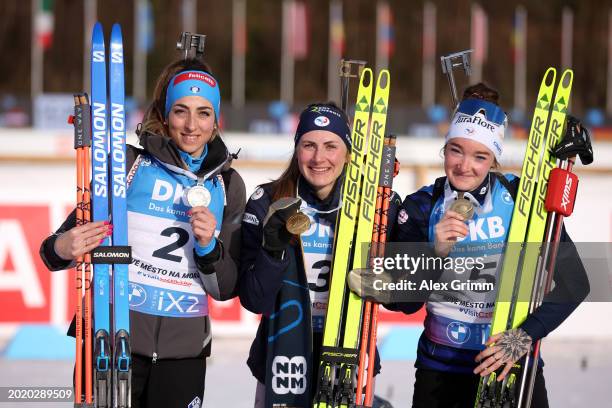 Silver medallist Lisa Vittozzi of Italy, Gold medallist Justine Braisaz-Bouchet of France and Bronze medallist Lou Jeanmonnot of France celebrate...