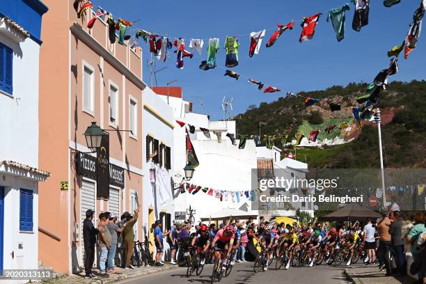 Remco Evenepoel of Belgium and Team Soudal - Quick Step - Yellow leader jersey and a general view of the peloton competing while fans cheer during...