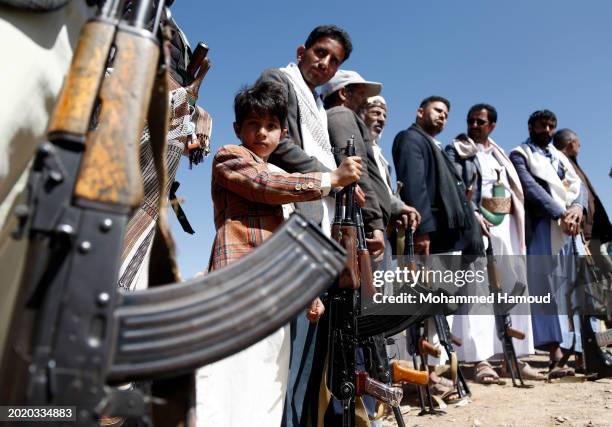 Yemen's Houthi followers hold their rifles as they participate in a rally staged in solidarity with Palestinians amid the military escalating in the...