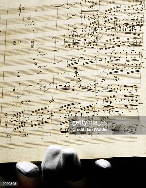 Sotheby's porter holds the manuscript for Ludwig van Beethoven's first edition of the Ninth Symphony as it goes under auction May 22, 2003 in London....