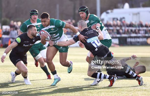 Reuben Bird-Tulloch of Ealing Trailfinders is tackled by Mike Brown of Leicester Tigers during the Premiership Rugby Cup match between Ealing...