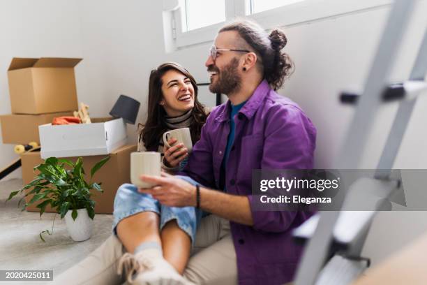 couple drinking first coffee at their new home - new girlfriend stock pictures, royalty-free photos & images