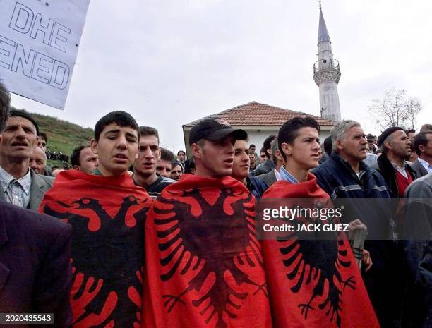 Up to 2000 Kosovo Albanians march in the southern Kosovo village of Krivenik 30 March 2001 calling on NATO-led peacekeepers to give them greater...