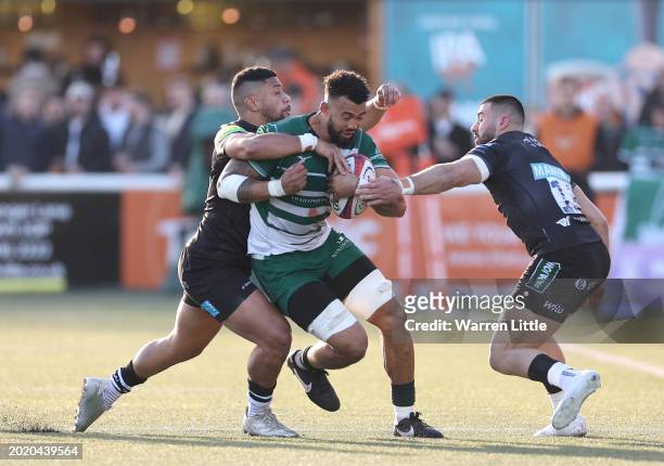 Bobby De Wee of Ealing Trailfinders is tackled by Phil Cokanasiga and Dan Kelly of Leicester Tigers during the Premiership Rugby Cup match between...