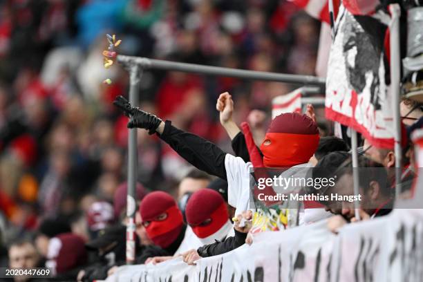 Fans throw sweets and chocolate onto the pitch in protest during the Bundesliga match between Sport-Club Freiburg and Eintracht Frankfurt at...