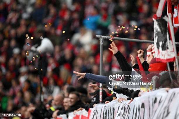 Fans throw sweets and chocolate onto the pitch in protest during the Bundesliga match between Sport-Club Freiburg and Eintracht Frankfurt at...