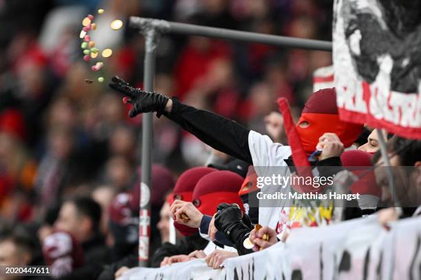 Fans throw sweets and chocolate onto the pitch in protest during the Bundesliga match between Sport-Club Freiburg and Eintracht Frankfurt at...