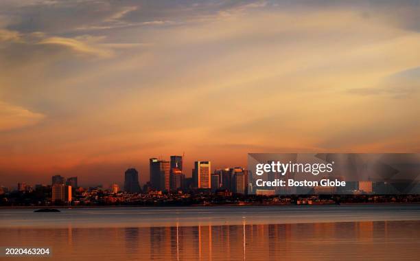 Quincy, MA The city of Boston is colored by an early morning sun seen from Quincy at sunrise.